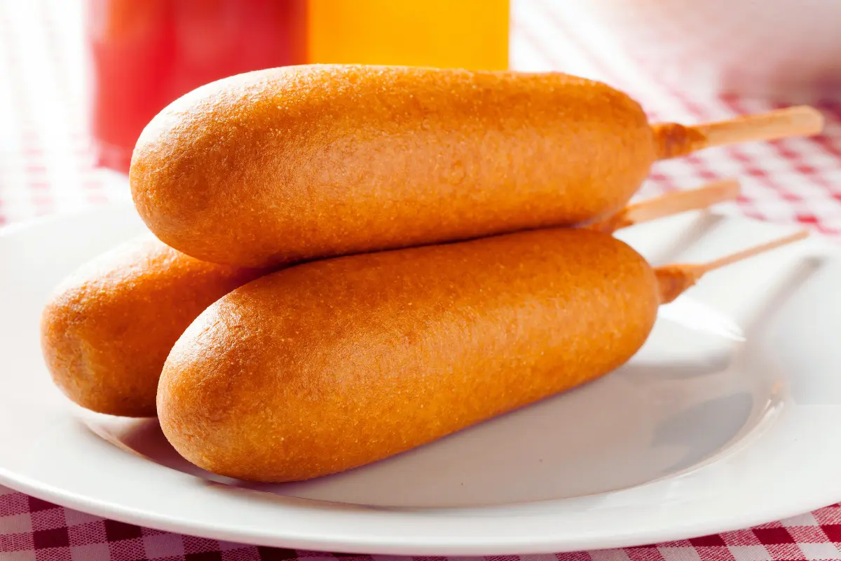 Golden Breakfast Corndogs on a plate with dipping sauce, perfect for a fun morning meal.